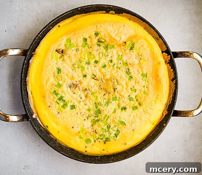 Effortless Egg Potato Frittata 6 Whisked eggs with green onions, salt, and pepper in a bowl.