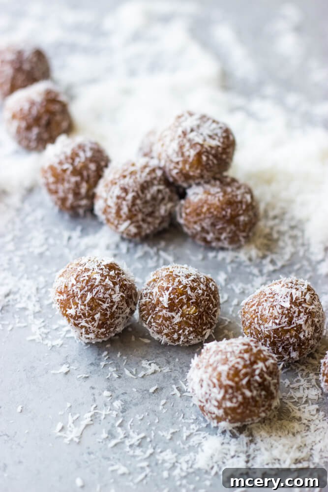 Date Coconut Truffles 3 date coconut balls arranged neatly on a wooden board