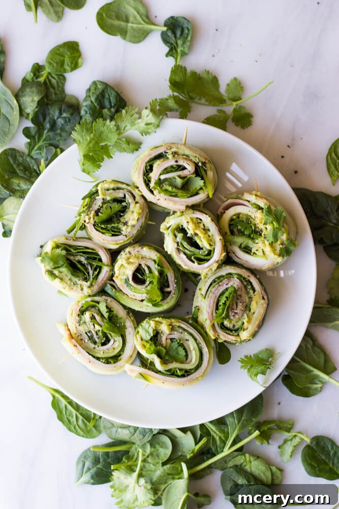 Refreshing Cucumber Bites 7 A platter of keto-friendly cucumber roll ups, garnished with fresh herbs, ready to be served