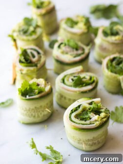 Ham and Cheese Cucumber Roll Ups - low carb and healthy roll ups with avocado-hummus, ham, cheese, cilantro, and spinach