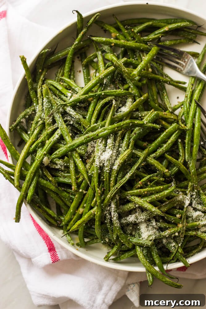 Garlic-Kissed Roasted Green Beans 6 Close up shot of oven roasted green beans with garlic and parmesan, showing tender texture and browned edges.