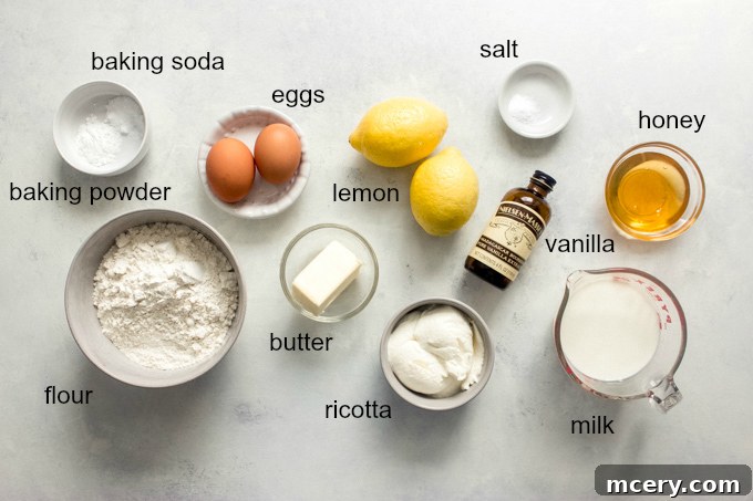 A selection of fresh ingredients for ricotta pancakes, including lemon and cheese