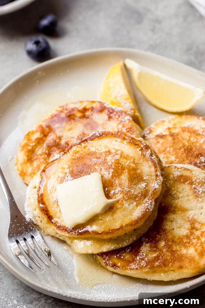 Lemon ricotta pancakes stacked high, ready to be served