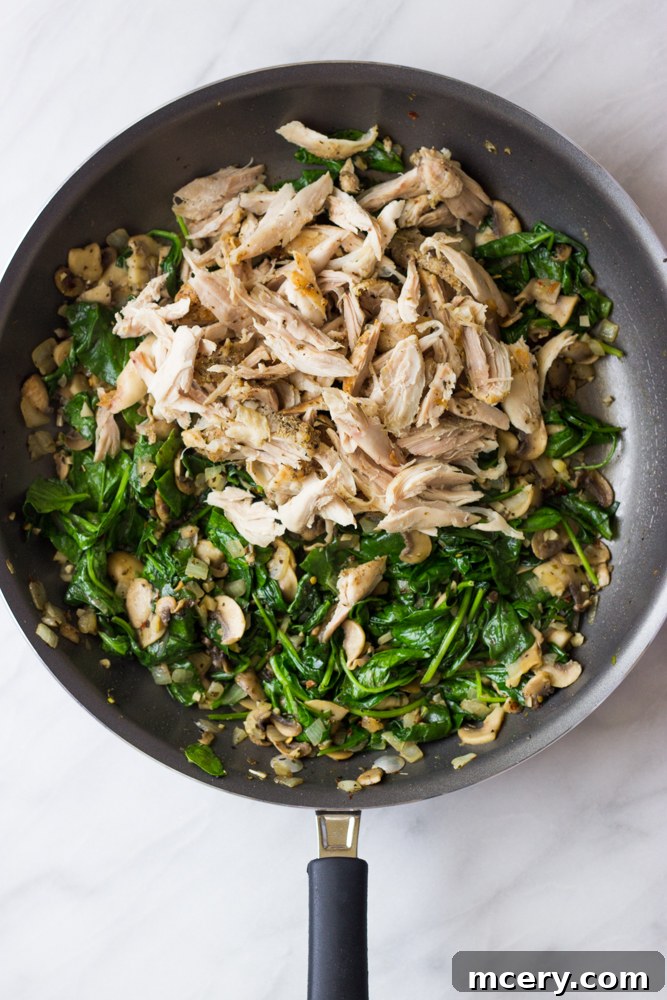 Creamy Chicken Lasagna with Spinach and Mushrooms 6 Cooked chicken, wilted spinach, and sautéed mushrooms combined in a skillet.