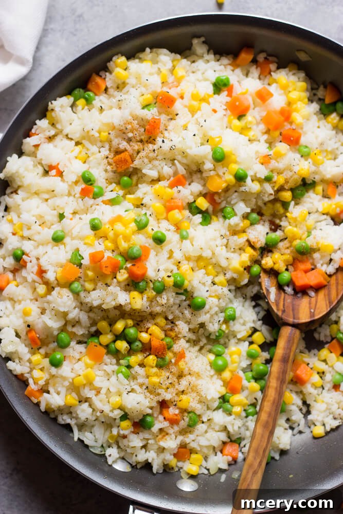Flavorful Mexican White Rice 2 Perfectly cooked Mexican white rice with vibrant vegetables in a skillet, ready to be served as a delightful side dish.