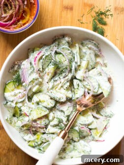 Greek Cucumber Salad - made with marinated onions and creamy Greek yogurt dressing. This simple summer side is insanely delicious and easy to make! | littlebroken.com @littlebroken