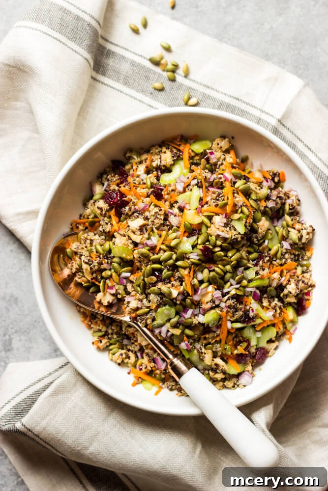 Mediterranean Chicken Quinoa Medley 2 easy quinoa salad in a bowl, garnished with fresh herbs.