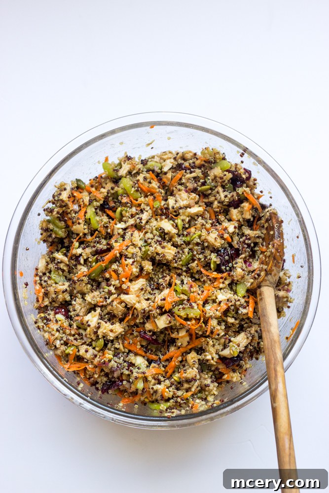 Mediterranean Chicken Quinoa Medley 9 fully mixed warm quinoa salad with chicken and dressing in a bowl.