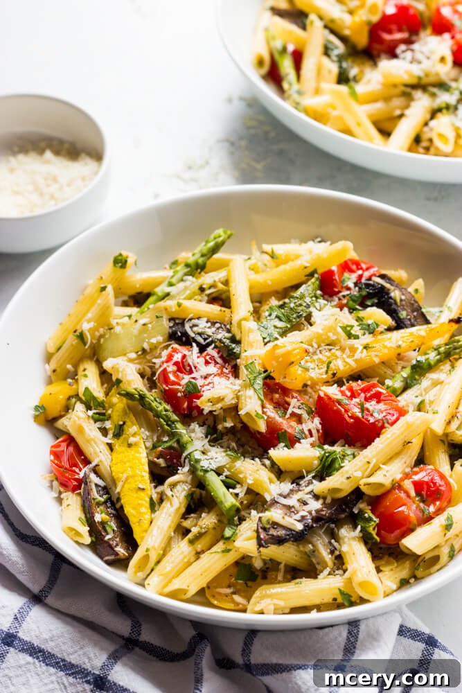 Rustic Roasted Vegetable Pasta 5 A close-up shot of a fork twirling luscious Pasta Primavera, highlighting the perfectly roasted vegetables and the rich tomato herb butter sauce.