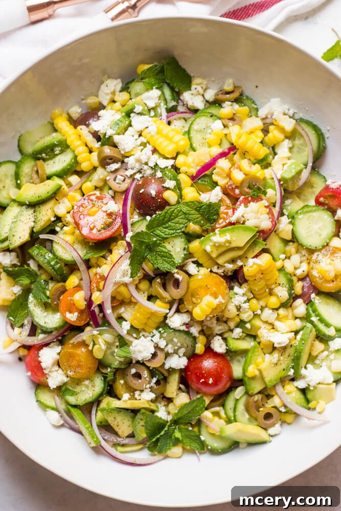 Vibrant Greek Corn Salad 6 Close-up of Greek Corn Salad with Avocado in a serving bowl, ready to be enjoyed. | littlebroken.com