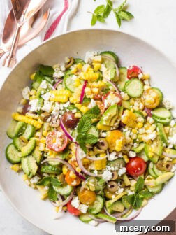 Delicious Greek Corn Salad with fresh ingredients like avocado, feta, and olives. | littlebroken.com