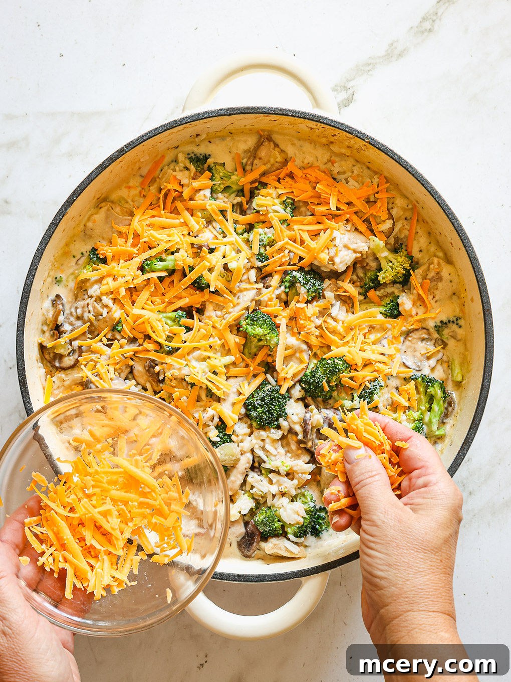 rice and chicken casserole topped with shredded cheddar cheese.