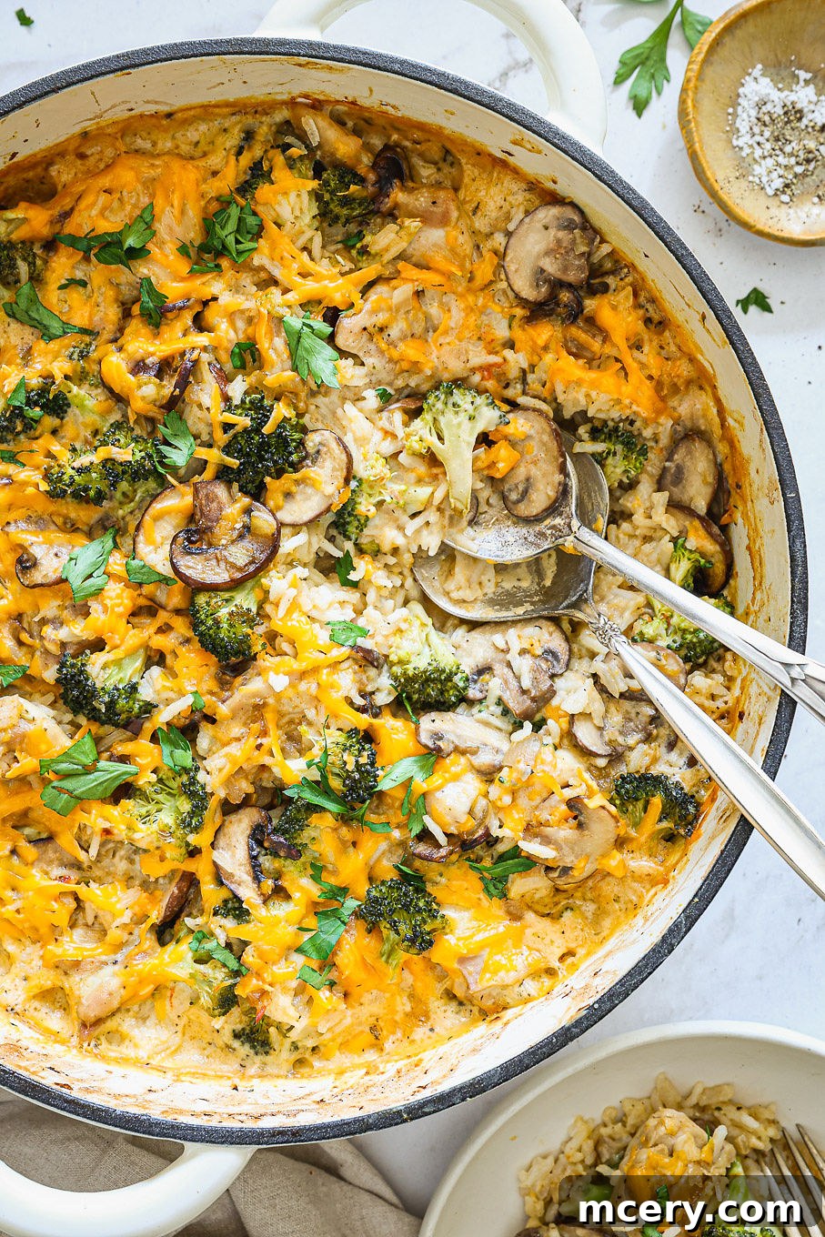 baked chicken rice casserole in a white saute pan.