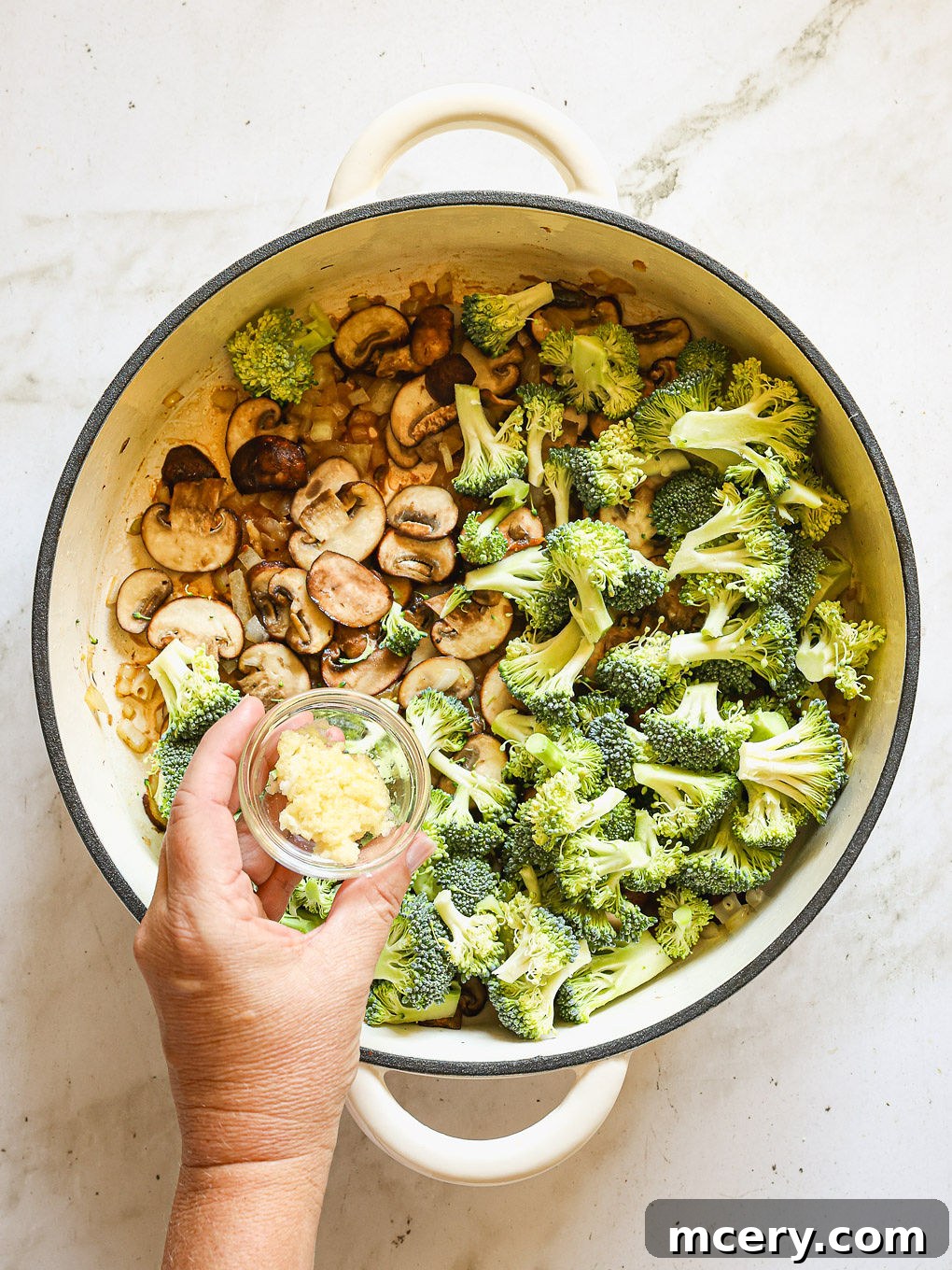 broccoli and mushrooms with garlic in skillet.