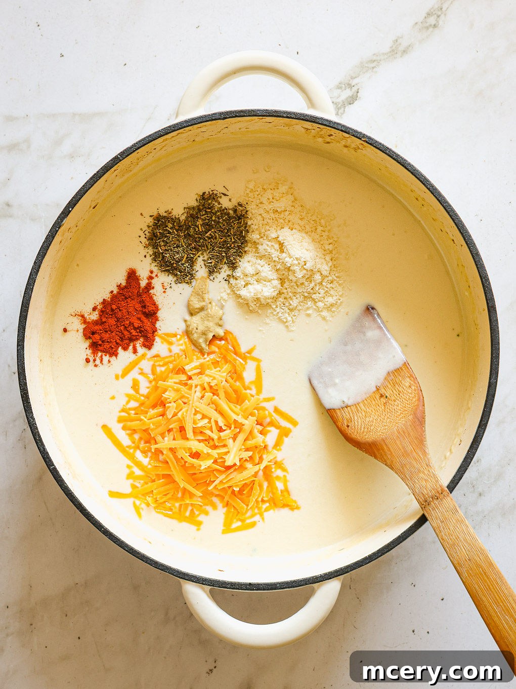 spices and cheese whisked into sauce.